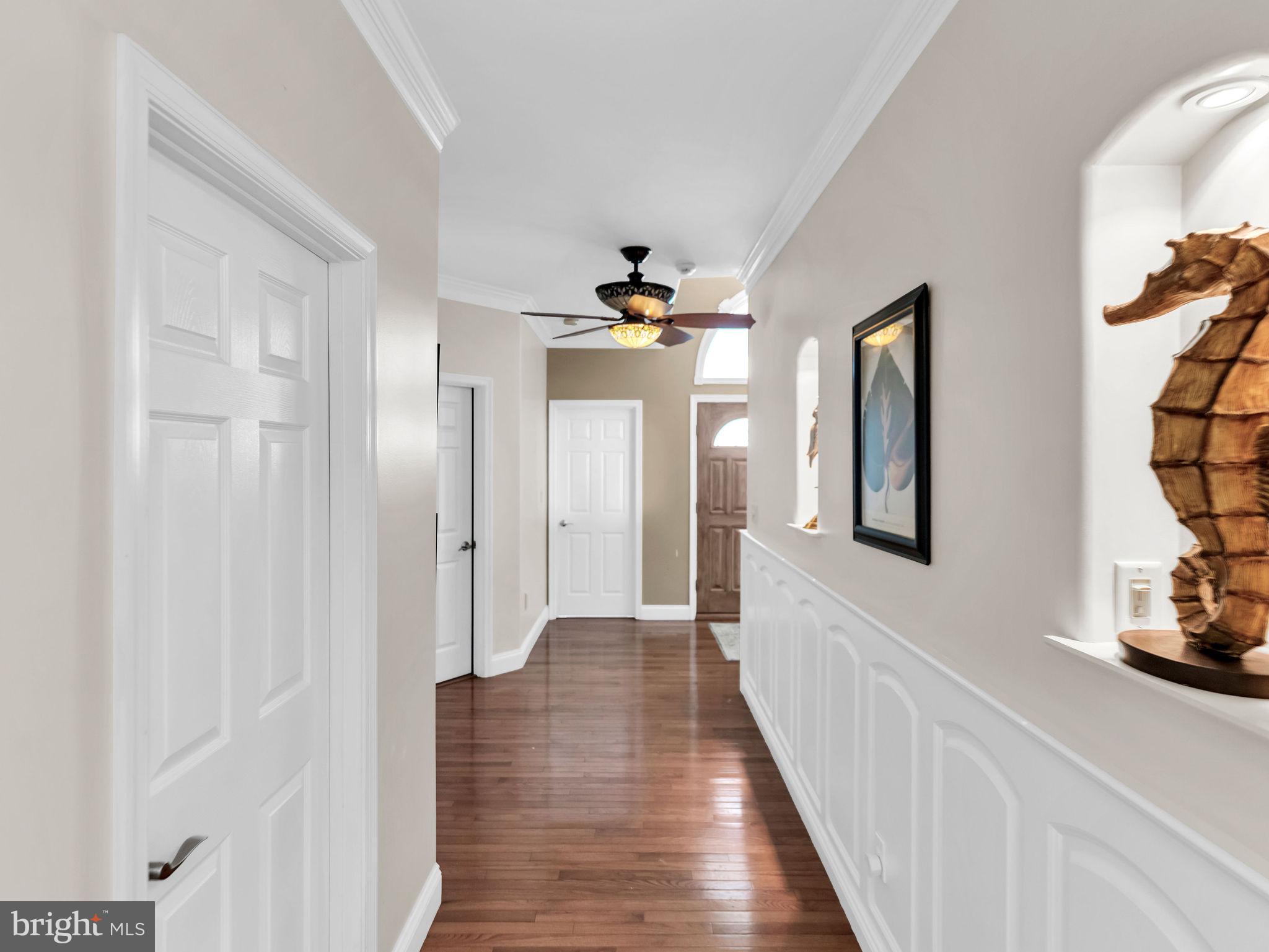 12608 Selsey Road Ocean City, MD 21842 - Photo 26 of 66 a view of a hallway with wooden floor and staircase
