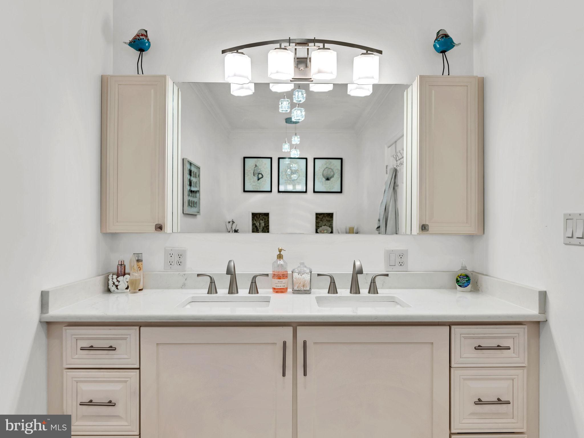 12608 Selsey Road Ocean City, MD 21842 - Photo 31 of 66 a bathroom with a sink and a mirror