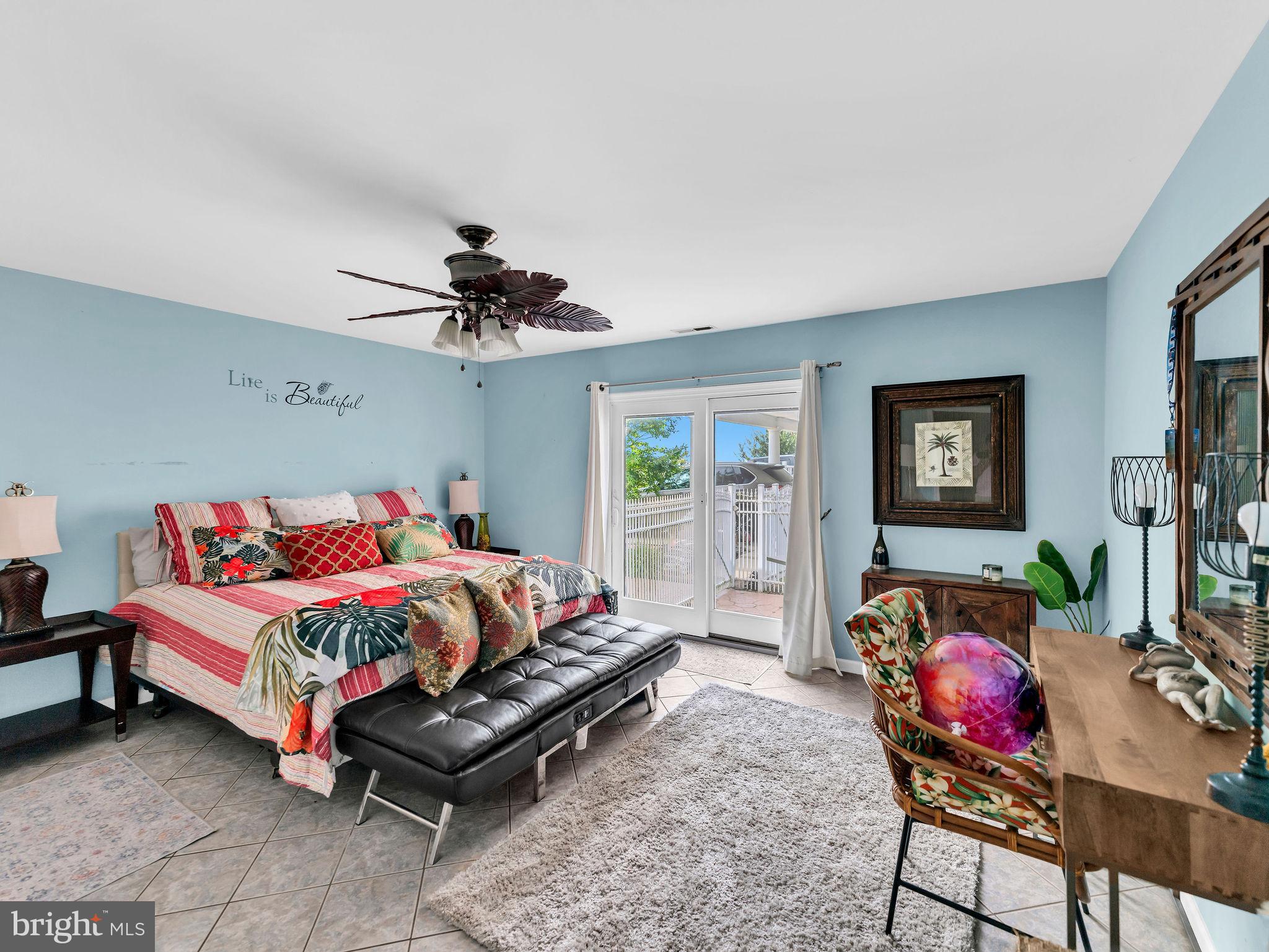 12608 Selsey Road Ocean City, MD 21842 - Photo 38 of 66 a bedroom with a bed and a chandelier