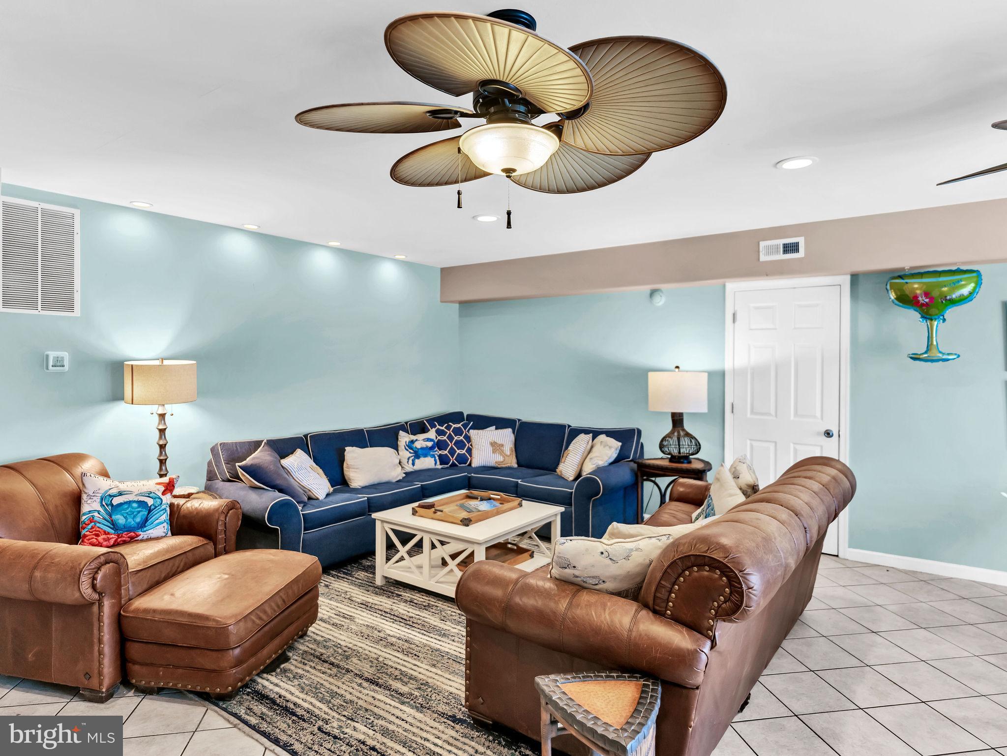 12608 Selsey Road Ocean City, MD 21842 - Photo 43 of 66 a living room with furniture a chandelier and a lamp