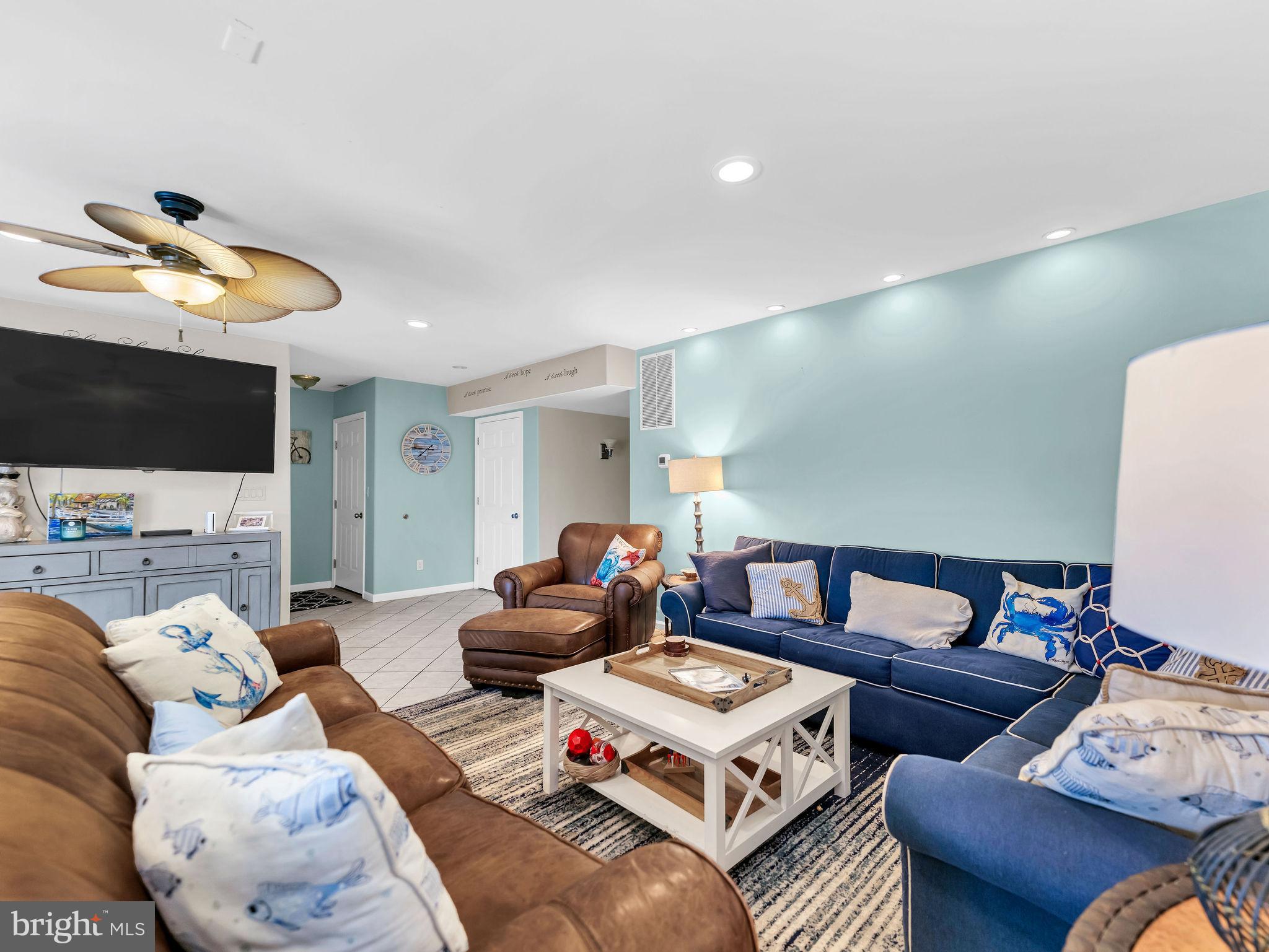 12608 Selsey Road Ocean City, MD 21842 - Photo 44 of 66 a living room with furniture a flat screen tv and kitchen view