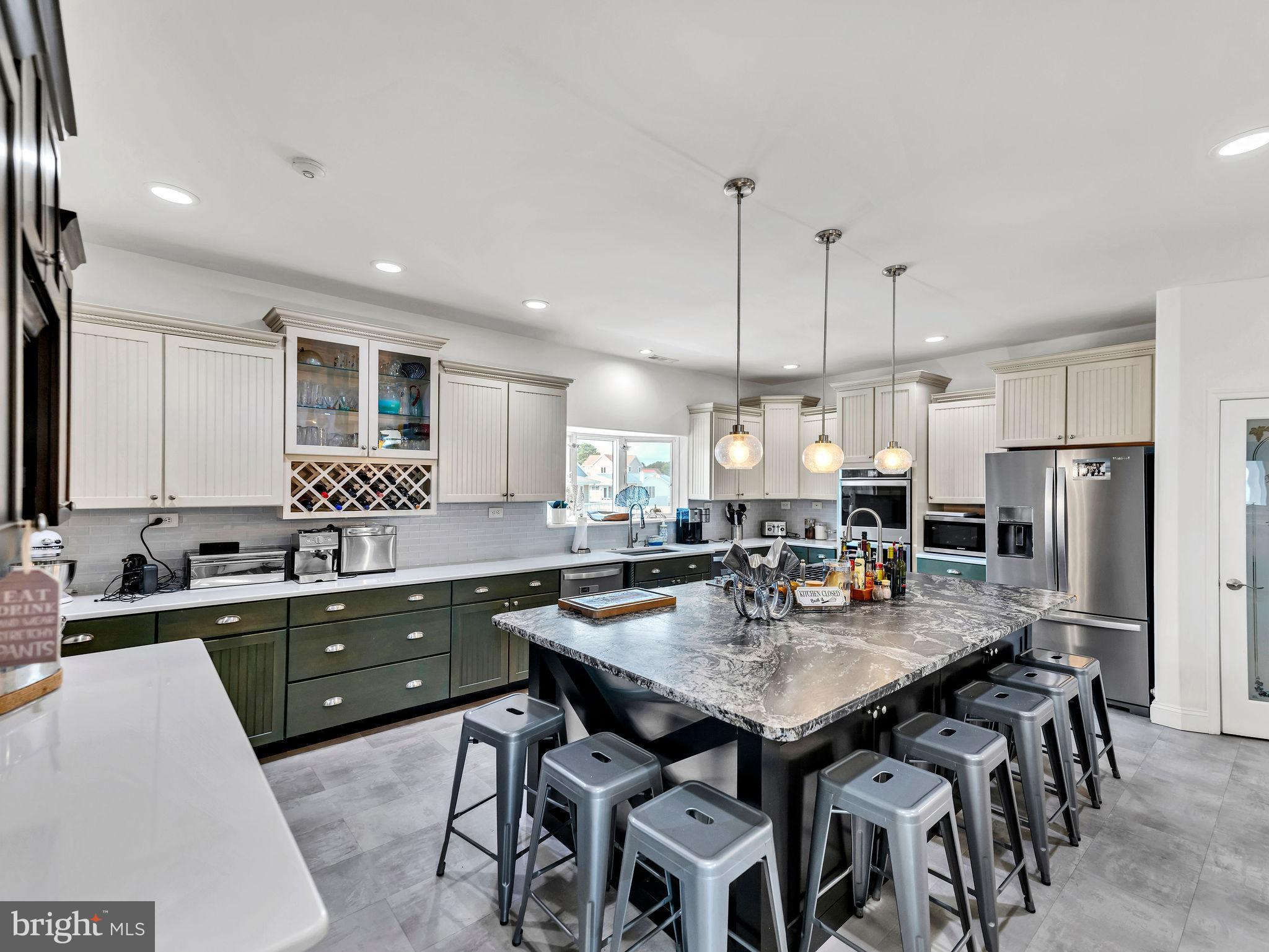 12608 Selsey Road Ocean City, MD 21842 - Photo 5 of 66 a kitchen with a table chairs sink and refrigerator