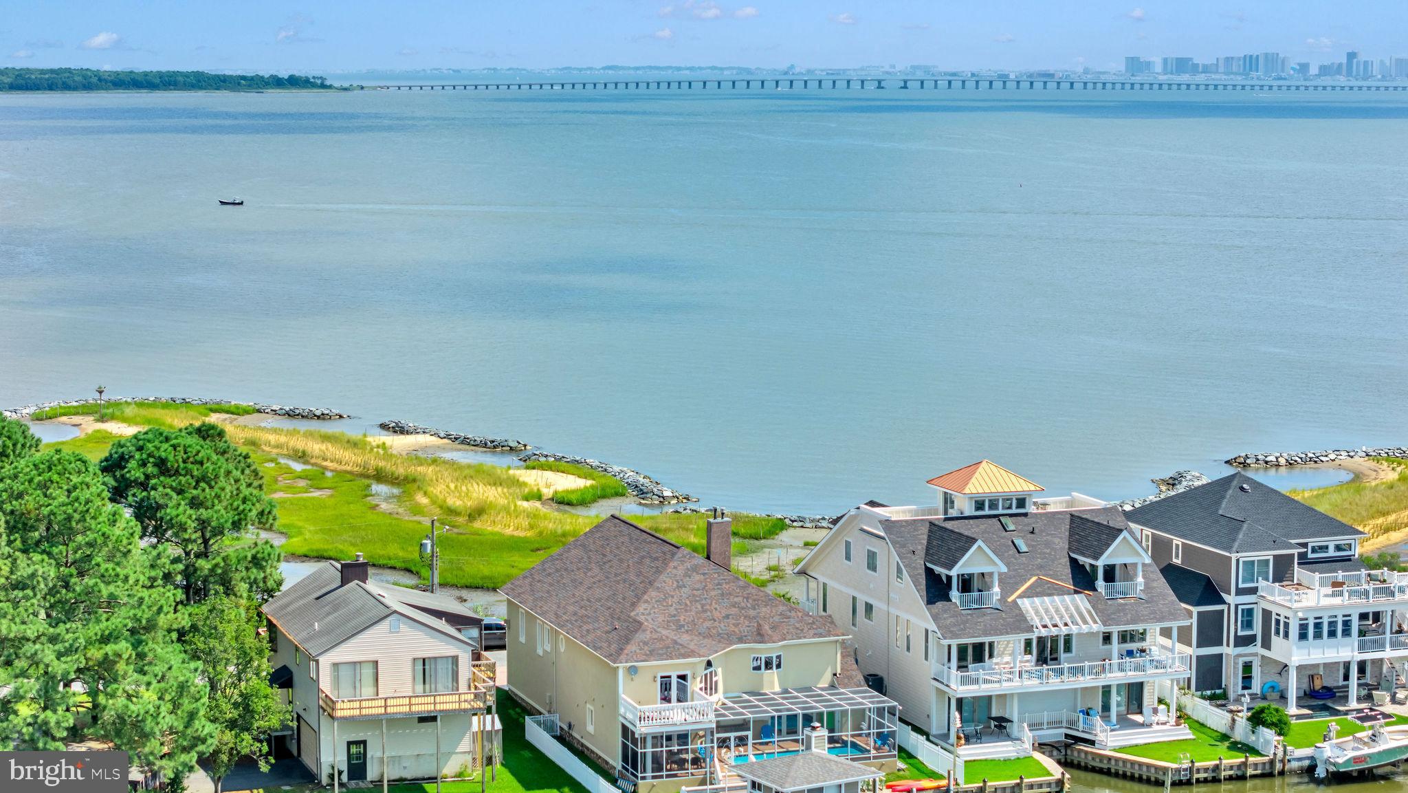 12608 Selsey Road Ocean City, MD 21842 - Photo 56 of 66 a view of a lake with a building in the background