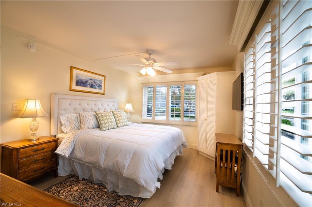 388 4th Avenue South, Unit 388 Naples, FL 34102 - Photo 1 of 15 a bedroom with a bed and a large window with outer view