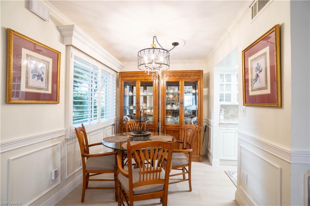 388 4th Avenue South, Unit 388 Naples, FL 34102 - Photo 11 of 15 a dining room with furniture a chandelier and window