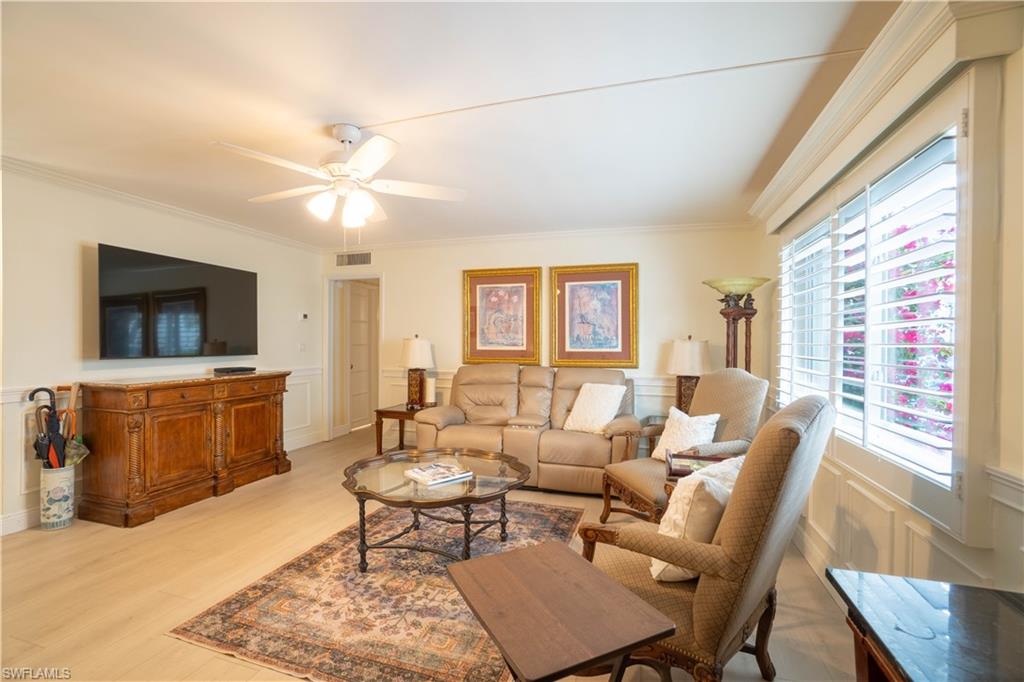 388 4th Avenue South, Unit 388 Naples, FL 34102 - Photo 12 of 15 a living room with furniture a flat screen tv and a window