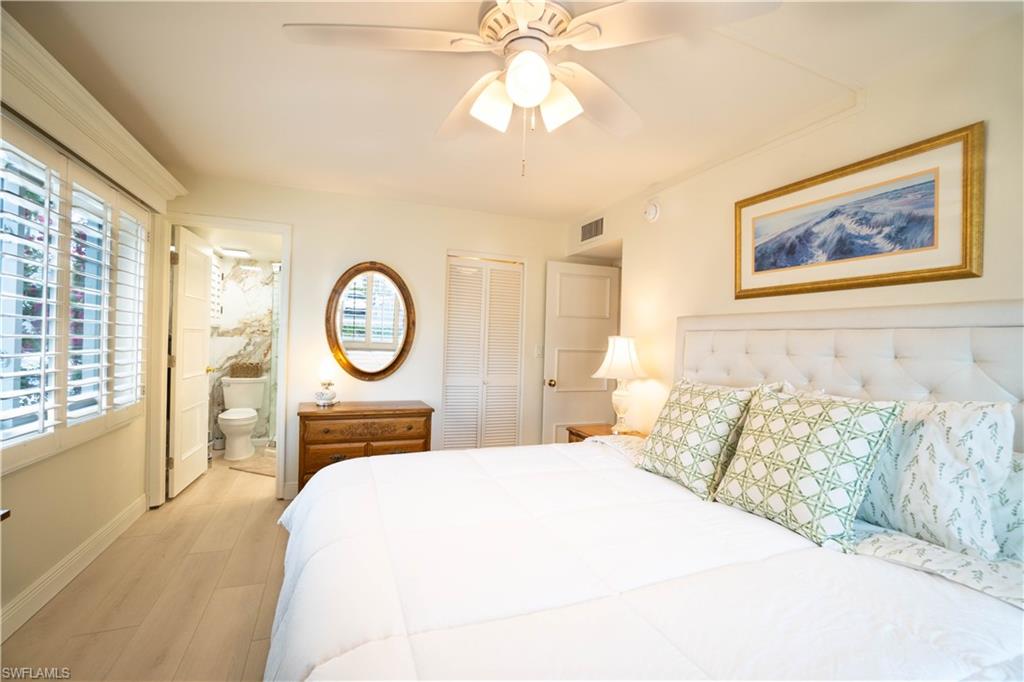 388 4th Avenue South, Unit 388 Naples, FL 34102 - Photo 3 of 15 a bedroom with a bed and a chandelier