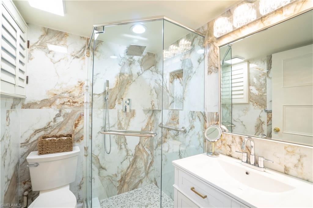 388 4th Avenue South, Unit 388 Naples, FL 34102 - Photo 4 of 15 a bathroom with a sink toilet and shower