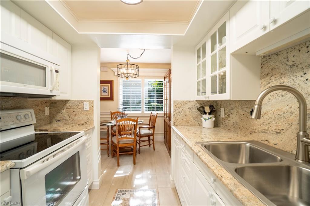 388 4th Avenue South, Unit 388 Naples, FL 34102 - Photo 9 of 15 a kitchen with a sink cabinets and window