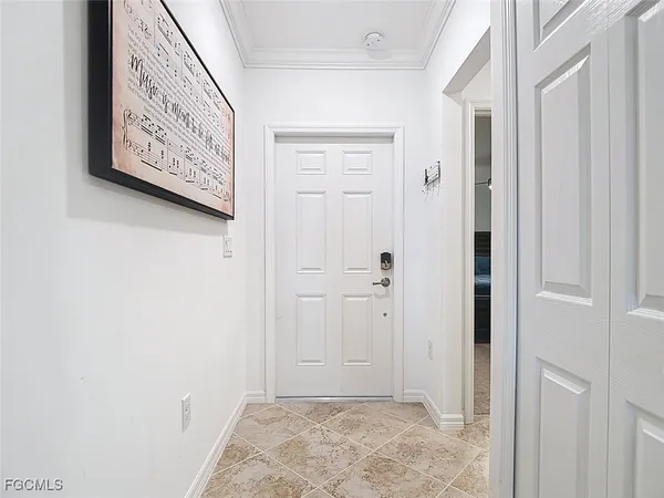a living room with furniture a chandelier and kitchen view