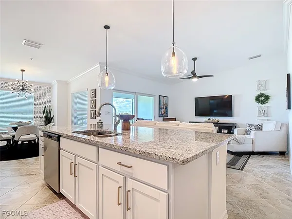a large kitchen with stainless steel appliances granite countertop a sink a stove and a wooden cabinets