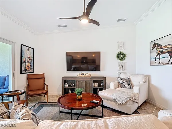 a living room with furniture and kitchen view
