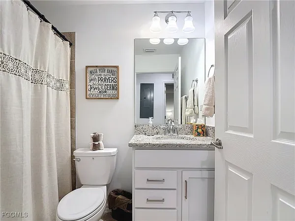 a bedroom with bed tv and flat screen tv