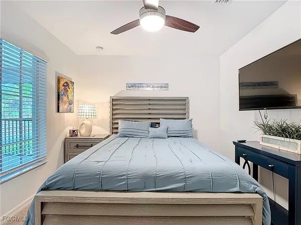 a bedroom with a large bed and a large window