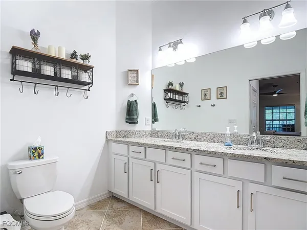 a bathroom with a granite countertop sink mirror and shower
