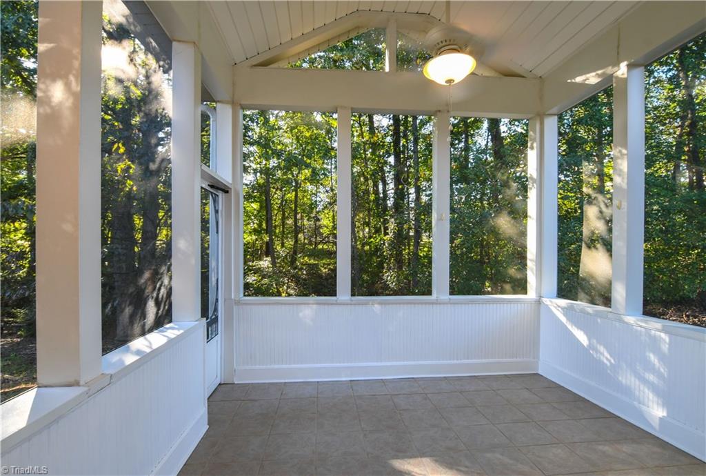 5407 Chestnut Ridge Drive Summerfield, NC 27358 - Photo 17 of 20 SPECIAL FEATURE! Screened porch with vault ceiling, new fan, tile floor. Backyard is wooded and backs up to 10 undeveloped acres!