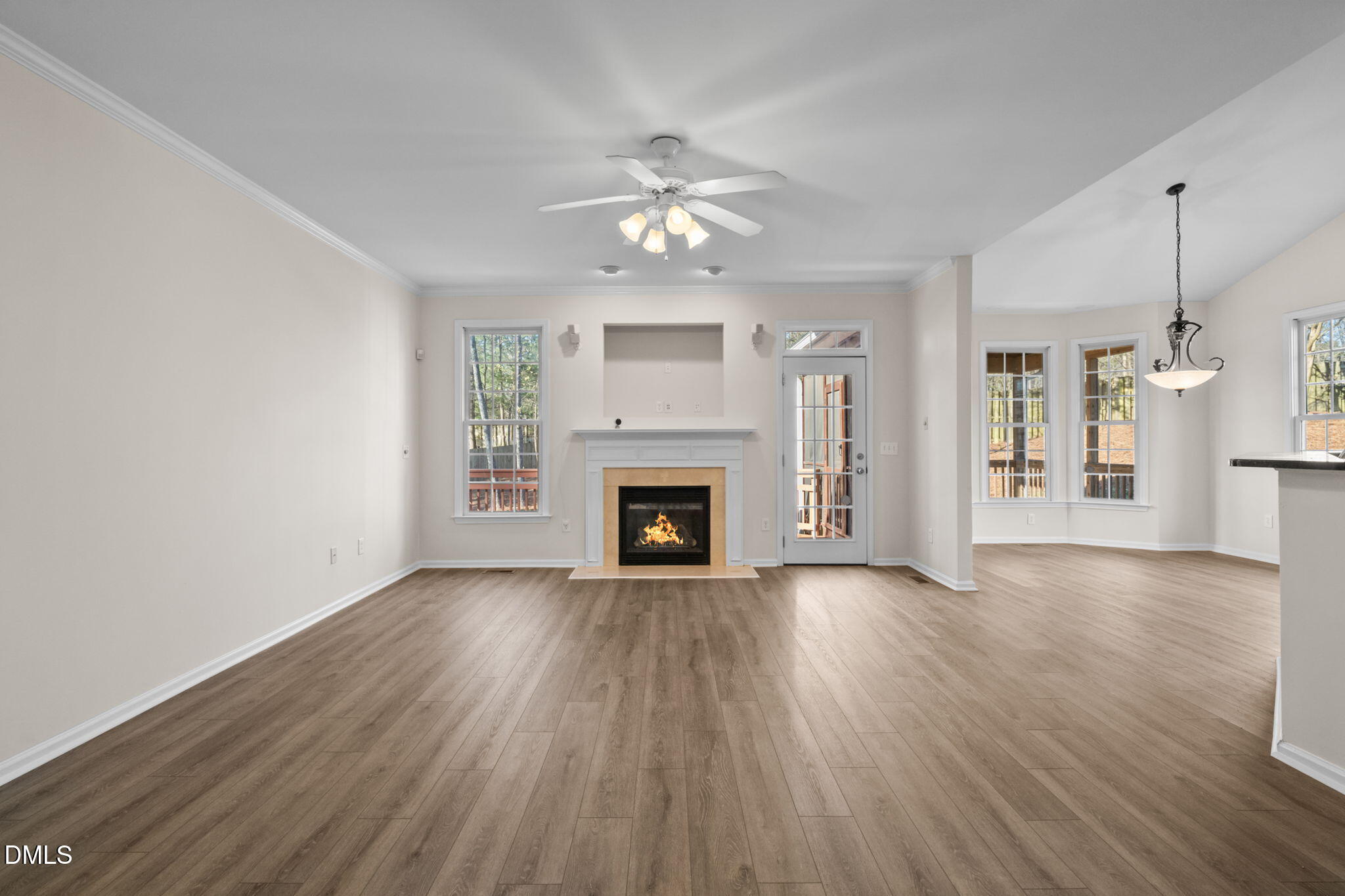 707 Martry Road Durham, NC 27713 - Photo 9 of 61 a view of a livingroom with a fireplace a ceiling fan and windows