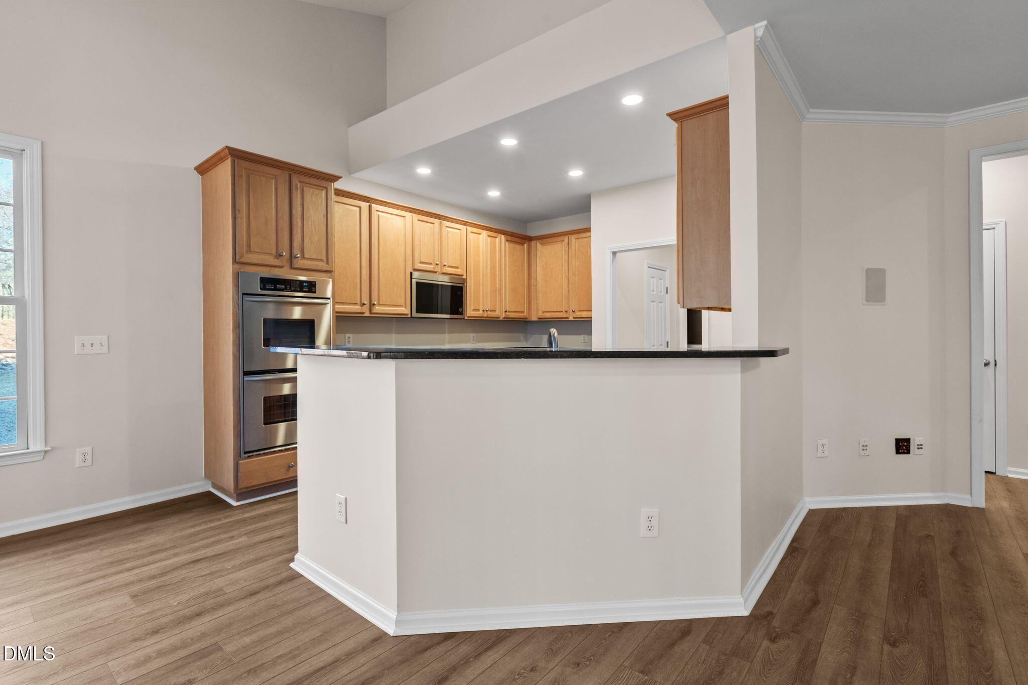 707 Martry Road Durham, NC 27713 - Photo 13 of 61 a kitchen with stainless steel appliances granite countertop a refrigerator a sink a stove and oven with wooden floor