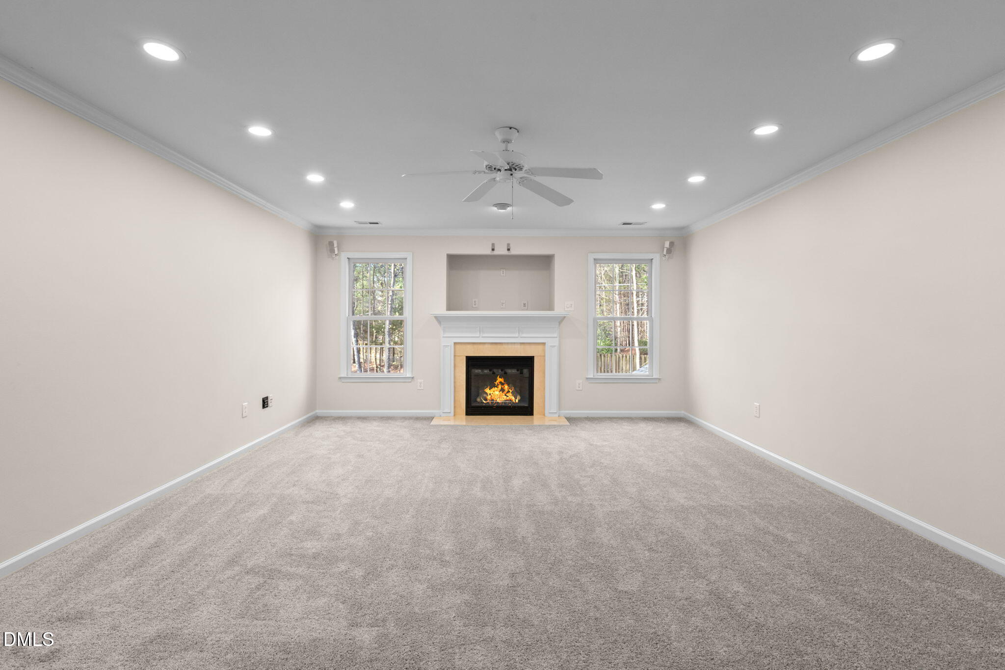 707 Martry Road Durham, NC 27713 - Photo 36 of 61 an empty room with a fireplace and chandelier fan