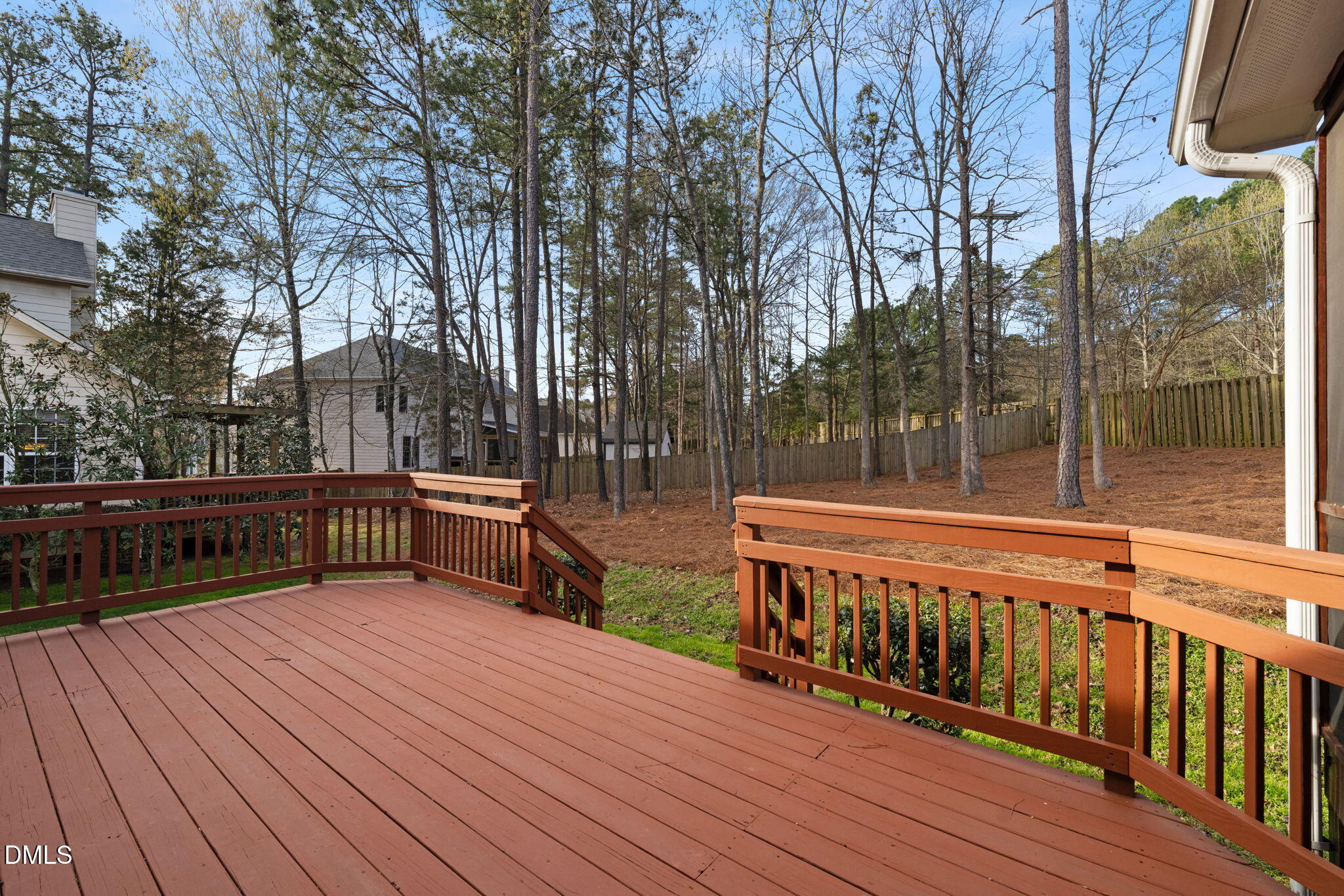 707 Martry Road Durham, NC 27713 - Photo 43 of 61 a view of a wooden deck with chairs and large trees