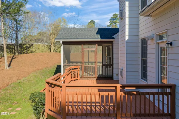 a front view of a house with a yard and potted plants