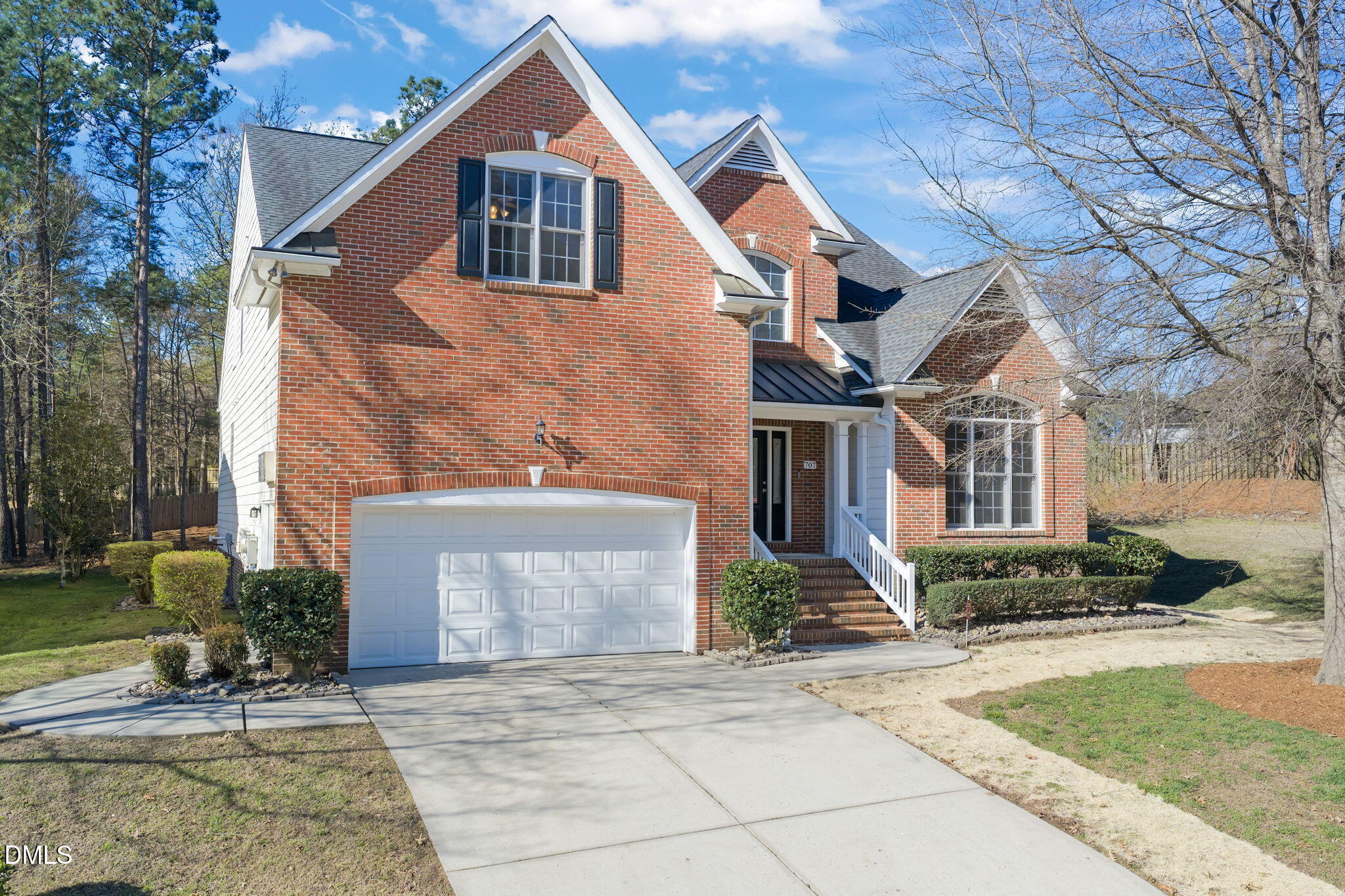 707 Martry Road Durham, NC 27713 - Photo 53 of 61 a front view of a house with a yard and potted plants