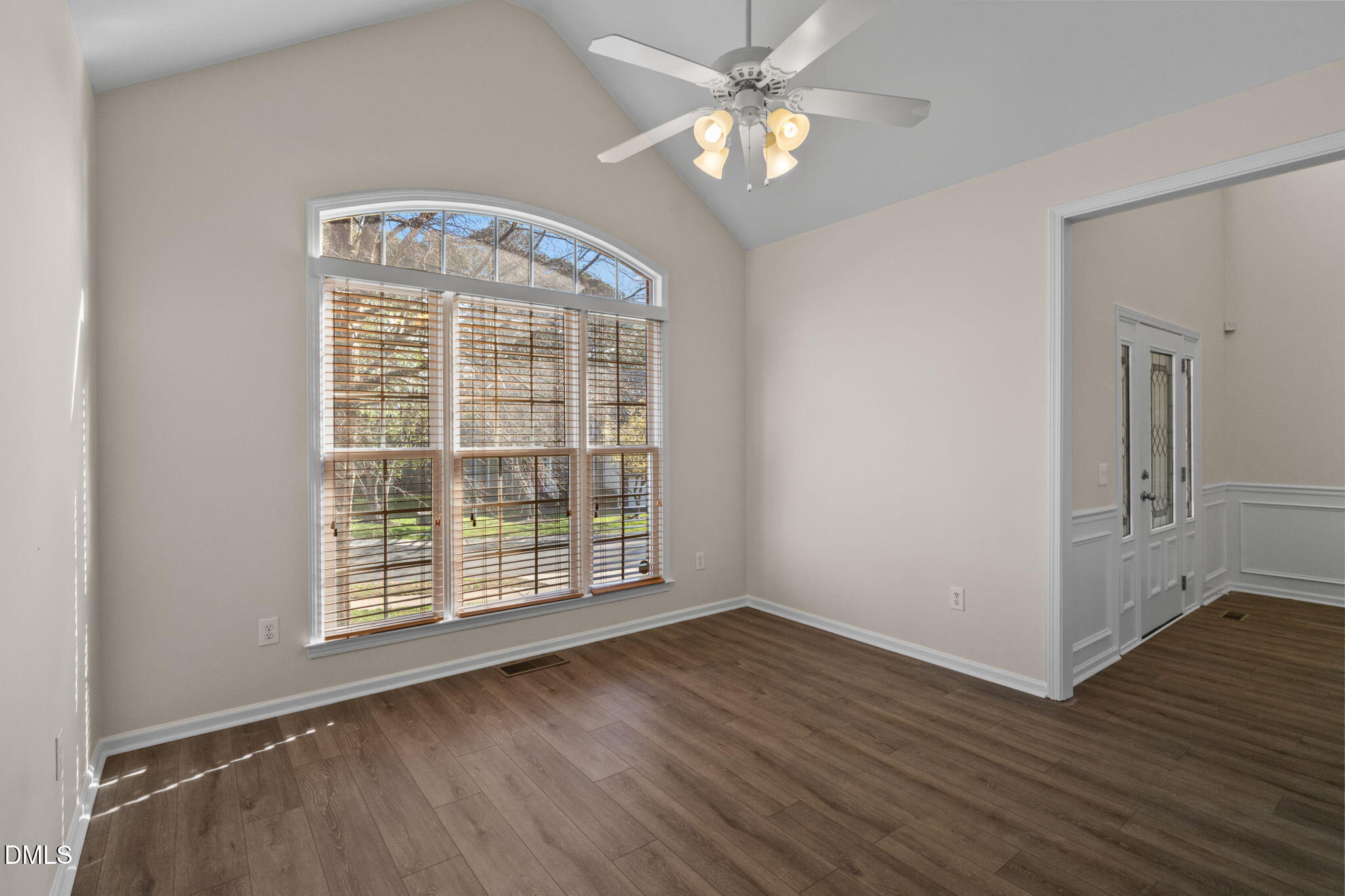 707 Martry Road Durham, NC 27713 - Photo 5 of 61 an empty room with wooden floor fan and windows