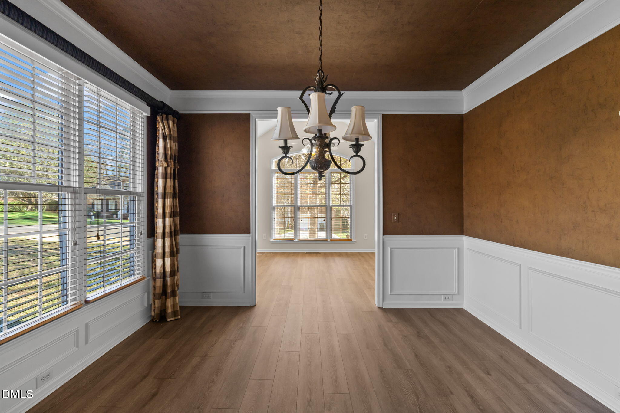 707 Martry Road Durham, NC 27713 - Photo 8 of 61 a view of an empty room with wooden floor and a window