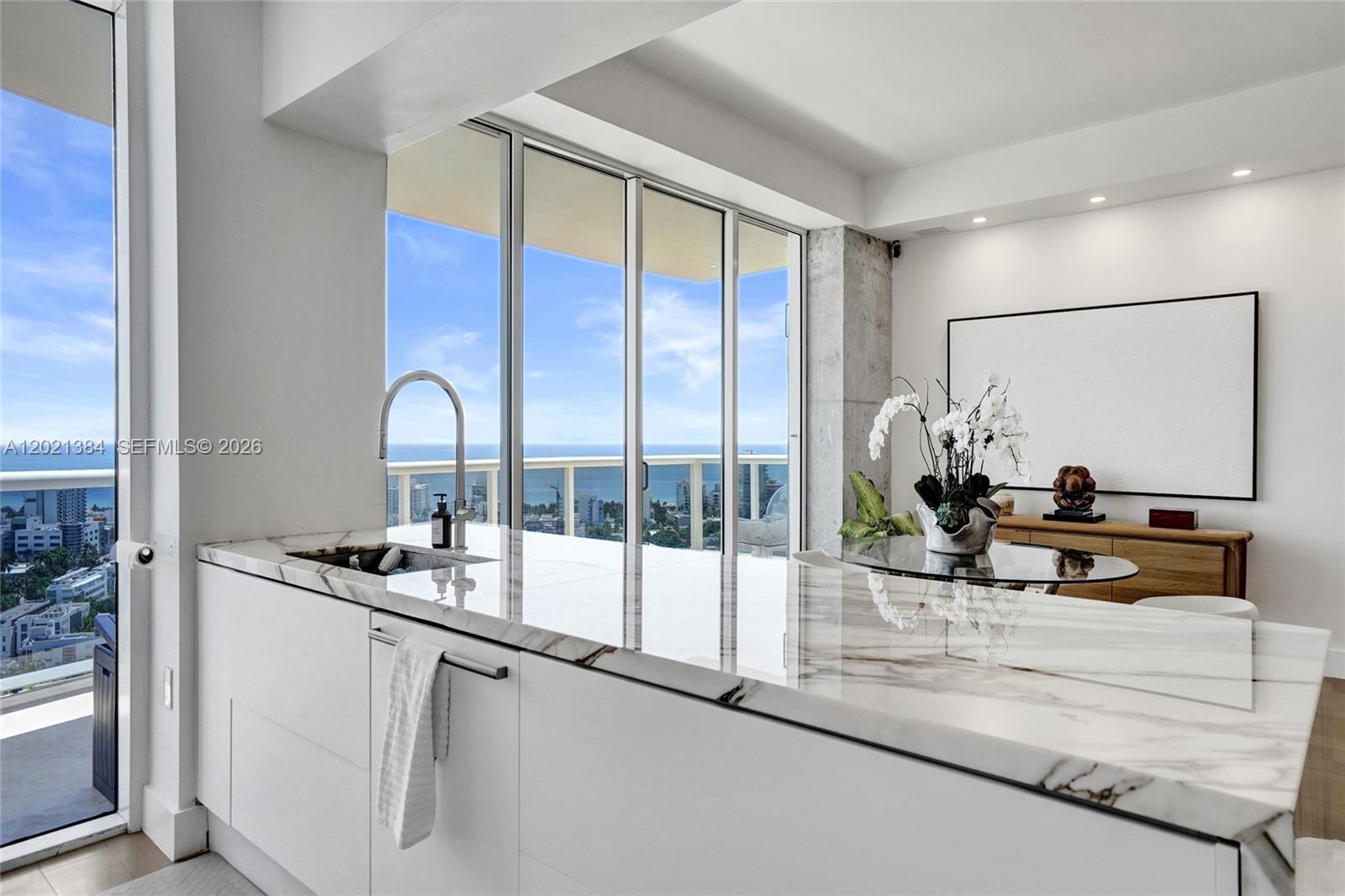 400 Alton Road, Unit PH11 Miami Beach, FL 33139 - Photo 6 of 49 a kitchen with stainless steel appliances a sink and cabinets
