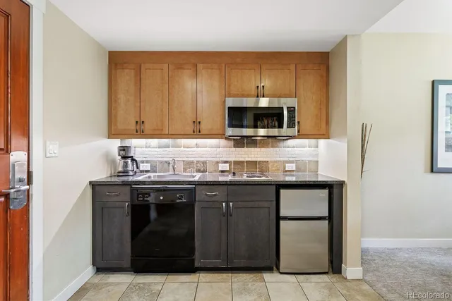 a kitchen with stainless steel appliances a stove and a microwave
