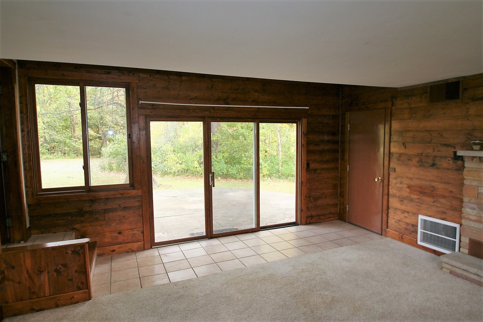 15998 Dee-Mac Road Mackinaw, IL 61755 - Photo 6 of 22 a view of an empty room with a fireplace and a window