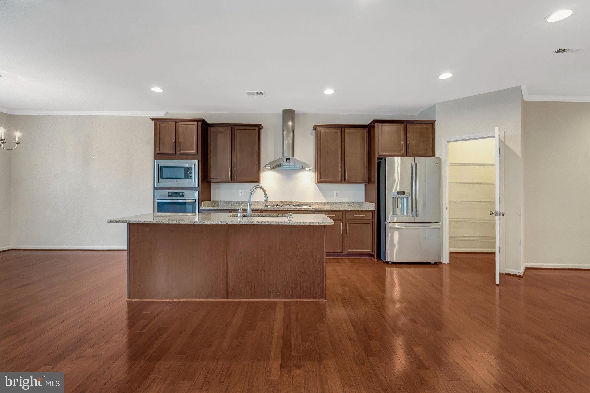 41841 Diabase Square Aldie, VA 20105 - Photo 11 of 45 a kitchen with stainless steel appliances granite countertop a refrigerator and a stove top oven
