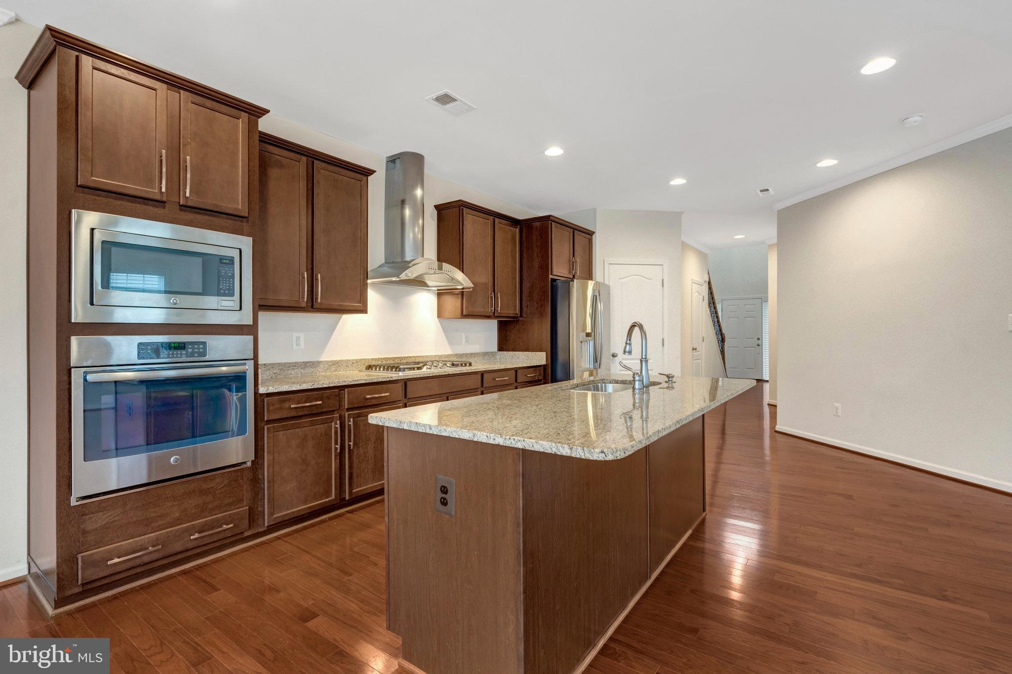41841 Diabase Square Aldie, VA 20105 - Photo 12 of 45 a kitchen with stainless steel appliances granite countertop a sink stove and refrigerator