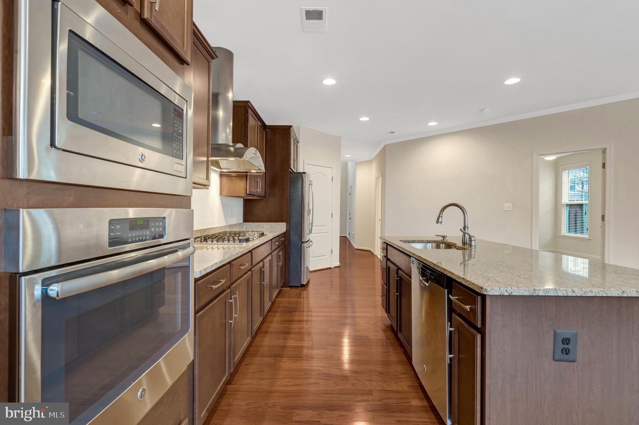 41841 Diabase Square Aldie, VA 20105 - Photo 13 of 45 a kitchen with stainless steel appliances granite countertop a sink and stove
