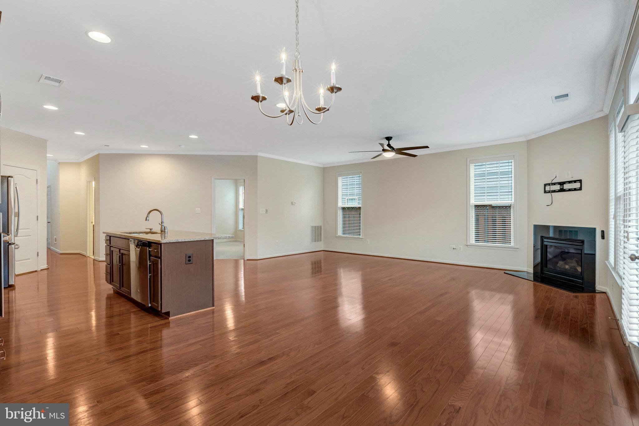 41841 Diabase Square Aldie, VA 20105 - Photo 9 of 45 a view of a livingroom with fireplace wooden floor and a ceiling fan