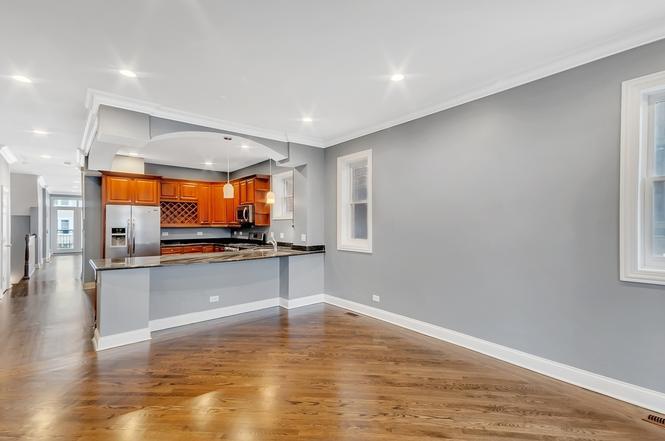 2417 West Fillmore Street, Unit 1 Chicago, IL 60612 - Photo 12 of 16 a view of a room with wooden floor and windows
