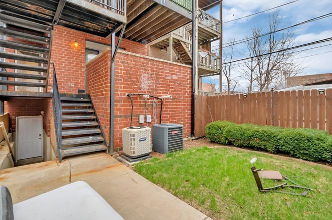 2417 West Fillmore Street, Unit 1 Chicago, IL 60612 - Photo 14 of 16 a backyard of a house with a garden and plants