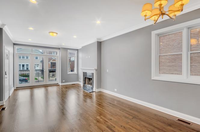 2417 West Fillmore Street, Unit 1 Chicago, IL 60612 - Photo 3 of 16 a view of an empty room with wooden floor and a window