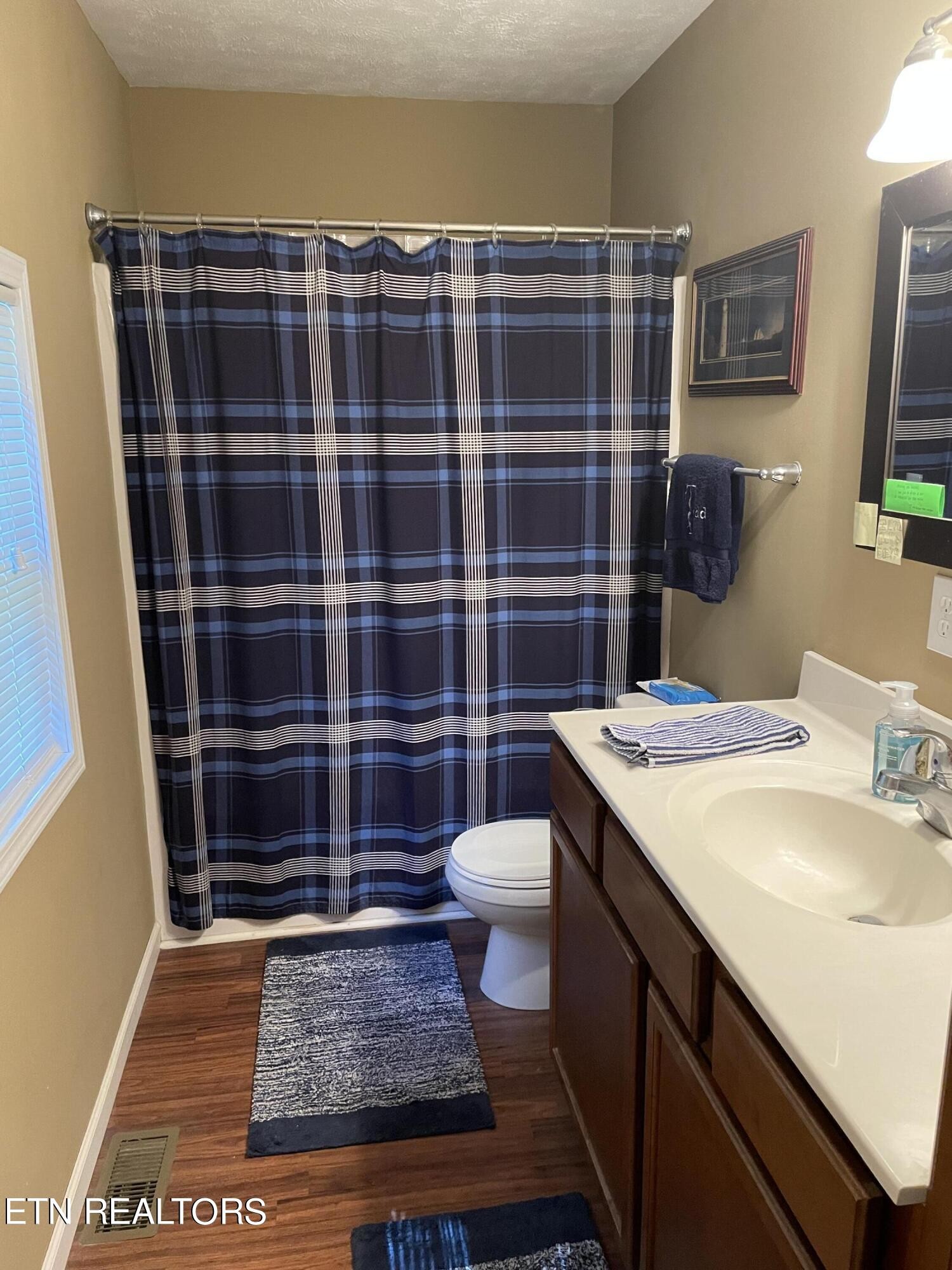 421 Delaware Avenue Oak Ridge, TN 37830 - Photo 28 of 34 a bathroom with a sink a toilet a shower and a mirror