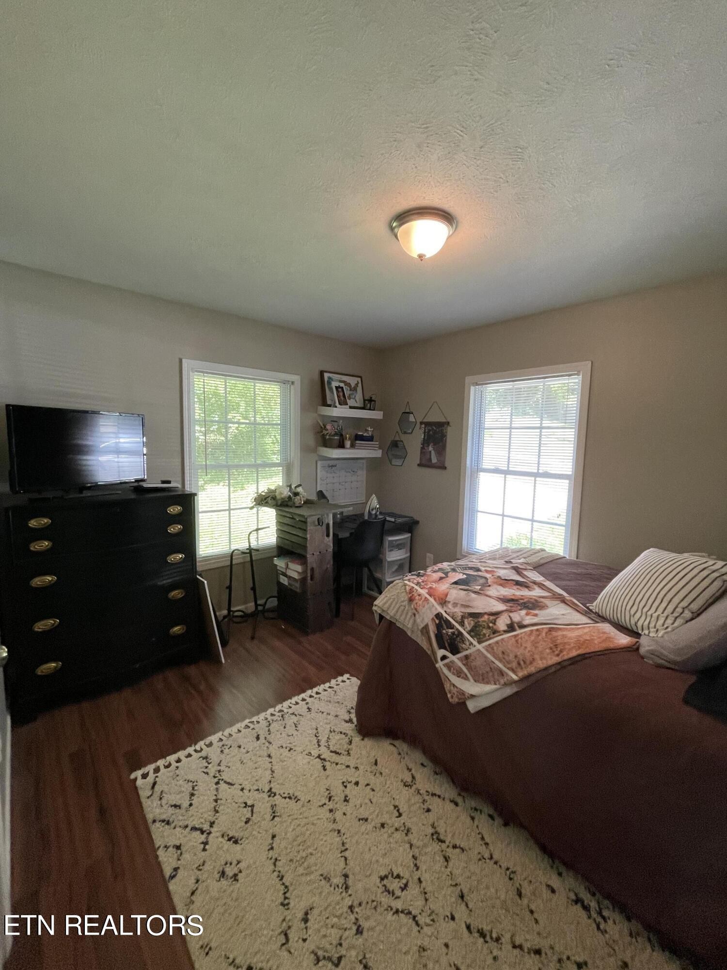 421 Delaware Avenue Oak Ridge, TN 37830 - Photo 33 of 34 a bedroom with a bed and wooden floor
