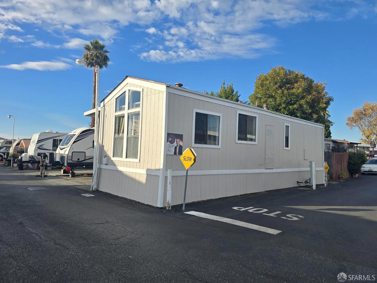 a view of a house with backyard and a tree