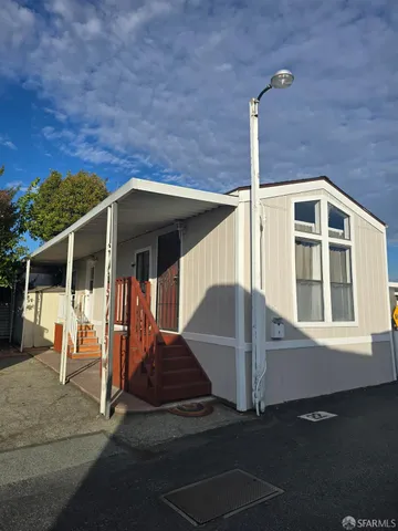a front view of a house with parking area