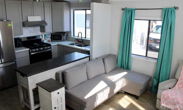 a kitchen with granite countertop a stove and a refrigerator