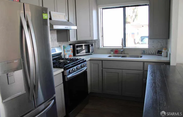 a kitchen with a sink stove and refrigerator