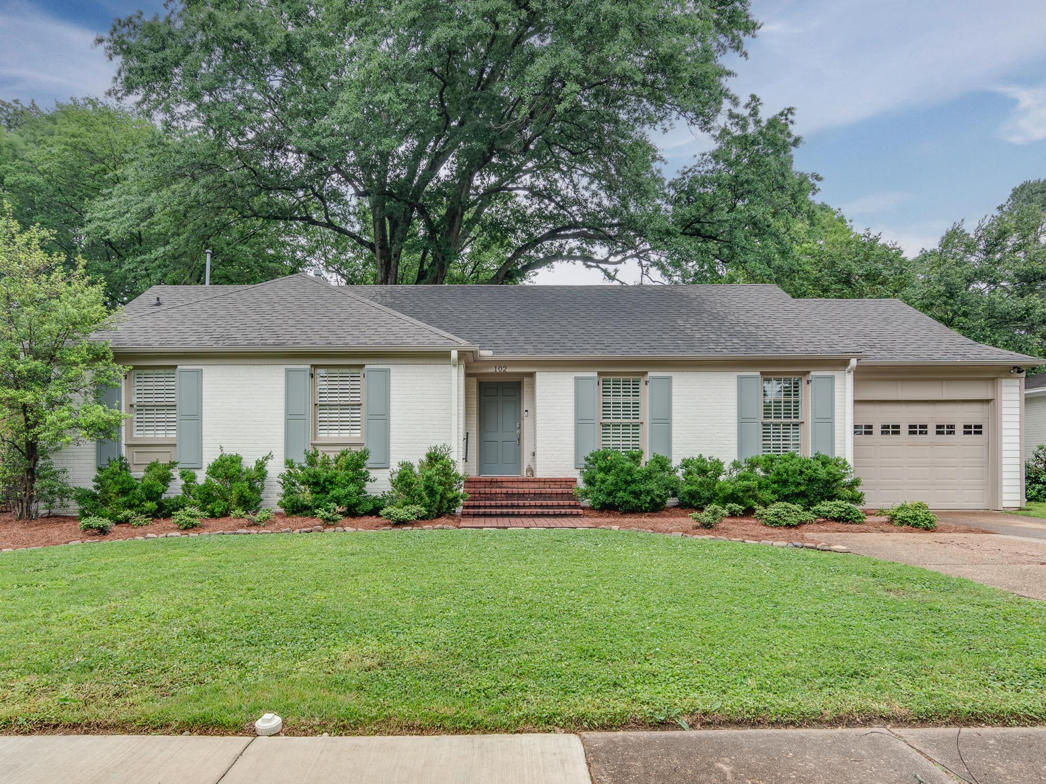 102 Fernway Road Memphis, TN 38117 - Photo 1 of 26 a front view of a house with a garden and yard