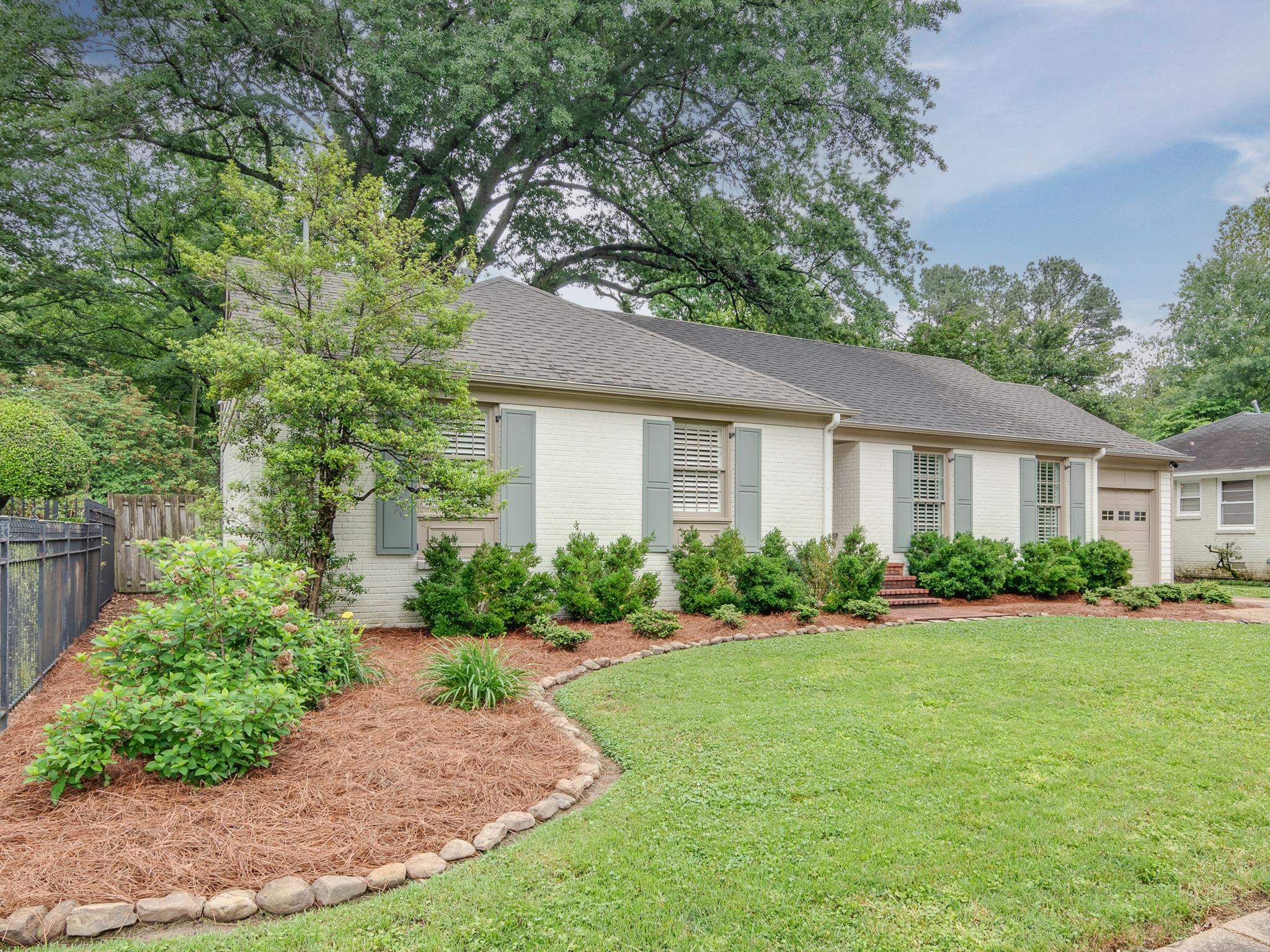 102 Fernway Road Memphis, TN 38117 - Photo 2 of 26 a front view of a house with a yard and trees