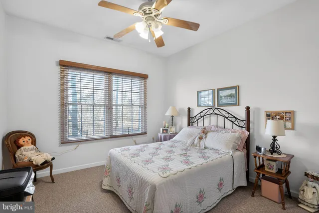 a spacious bedroom with a bed and a window