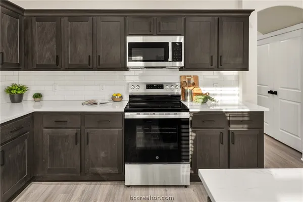 a kitchen with a cabinets and steel stove