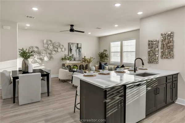 a kitchen with sink and living room