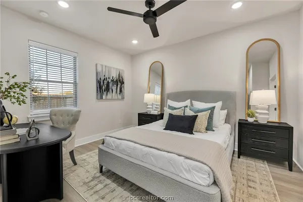 a bedroom with bed and wooden floor